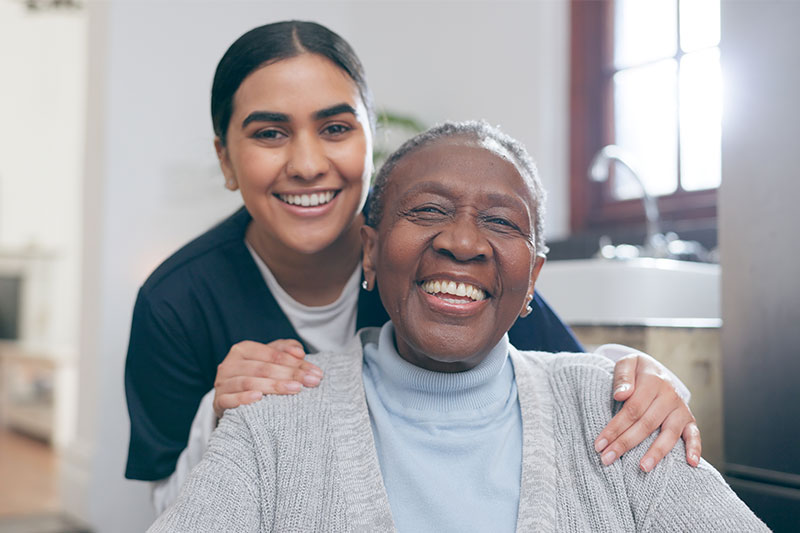 A Grass Valley caregiver smiles with an older woman.